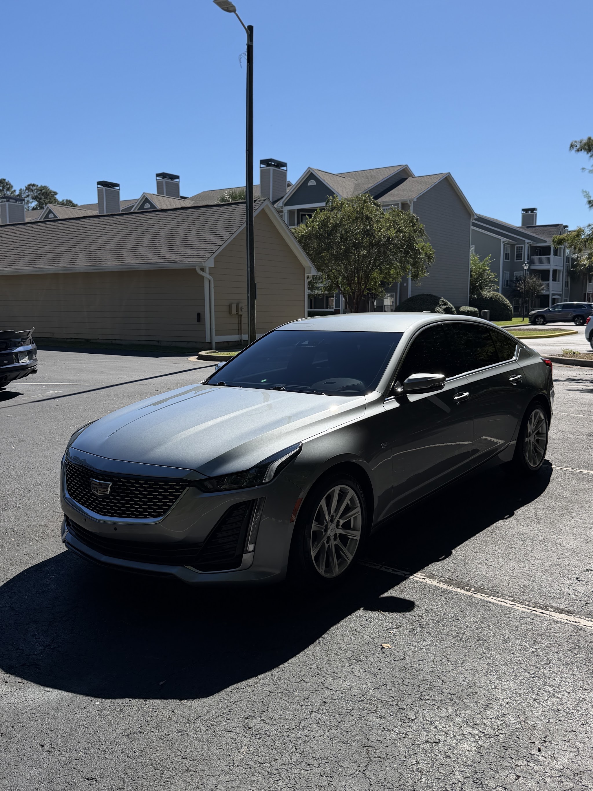 Silver Cadillac sedan after a wash and wax